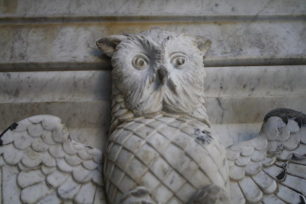 Mramorna skulptura sove raširenih krila, klesarski detalj na nadgrobnom spomeniku na groblju.